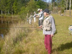 Members on a private dam removing excess silver perch