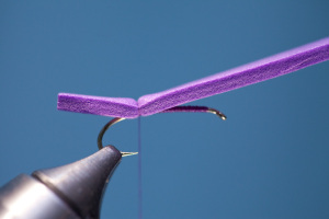 Place the foam strip on top of hook. Next, line up the thumbnail mark in foam with the point of hook. Bind down foam with 5-6 firm wraps of foam.