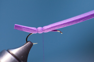 Advance thread forward, on hook only, about a quarter of the way to eye of hook. Bind down foam with 5-6 firm wraps of thread.