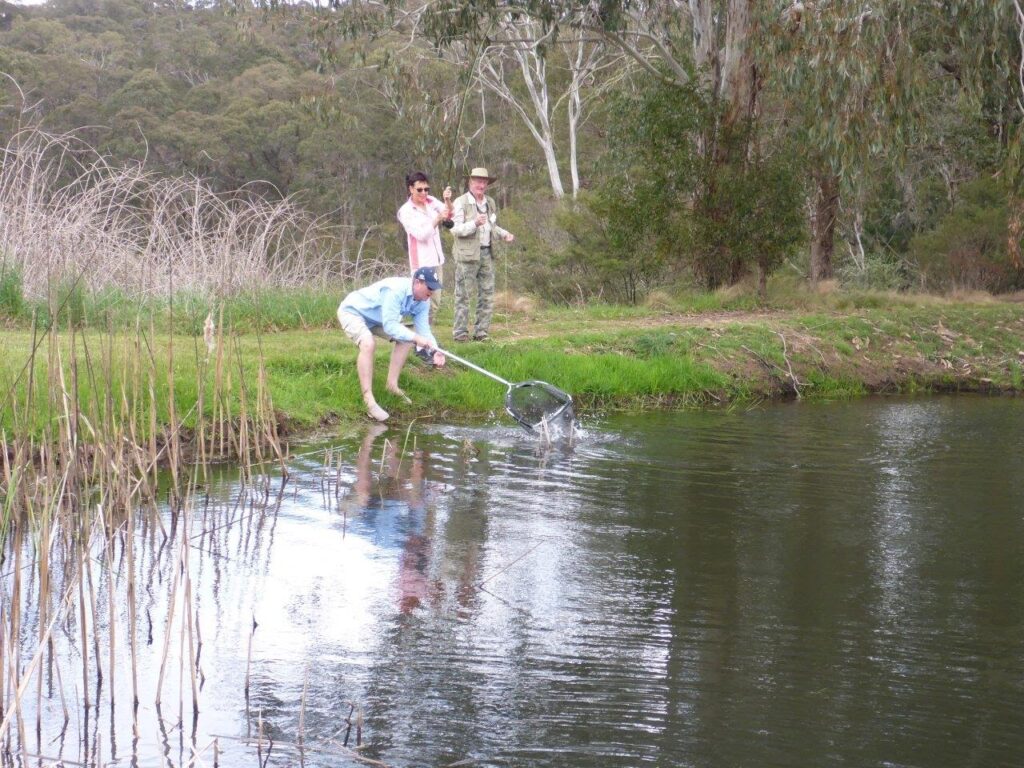 Lee bringing a Casting for Recovery participant's trout to the net.