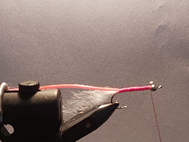 Tie in Pink tubing, run thread to back of bead chain.