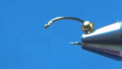 Hook with crushed barb and gold bead added, bead slid back from the hook eye.