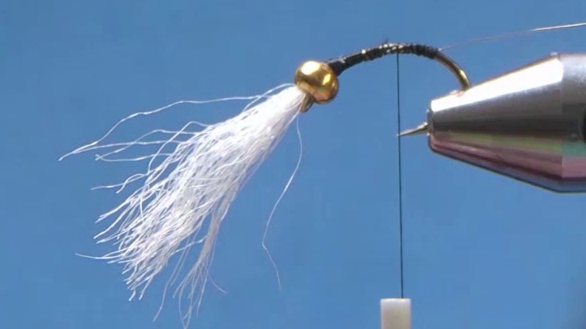 Bead pushed to the hook eye, thread reattached, silver wire ribbing tied in and thread wrapped to the bend.