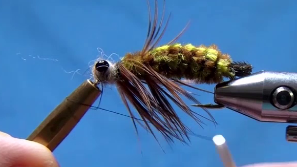 Finished fly with legs and fibres neatly trained back and downward; sleek, lifelike silhouette of a dragonfly nymph.