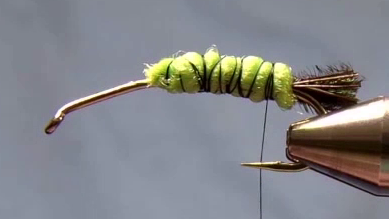 Layered poly yarn now fully covers both sides and top of the hook shank, building bulk for the nymph body.