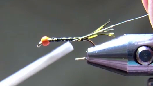Fine silver wire tied along the near side of the hook, extending toward the rear over the thread base.
