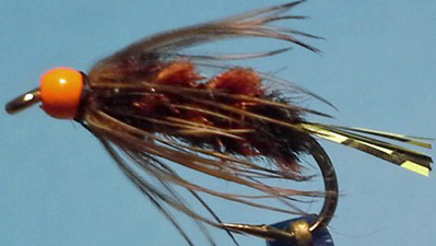 Final fly with hackle fibres gently trained rearward, showing a finished profile ready for fishing.