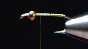 Hook with copper bead in place, thread wrapped to cover the shank.