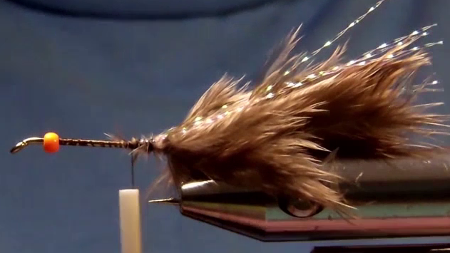 Two Mallee fowl feathers tied as tail, splayed outward, with strands of Krystal Flash on each side.