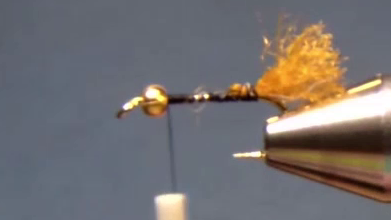 Hook with bead and thread, amber Shuck Yarn tail tied in.