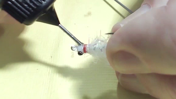 UV resin being layered and shaped around the eyes, forming a smooth, rounded head.